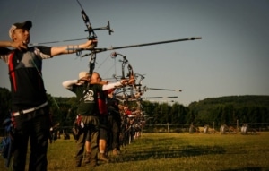 Line of olympic recurve archers outdoor archery